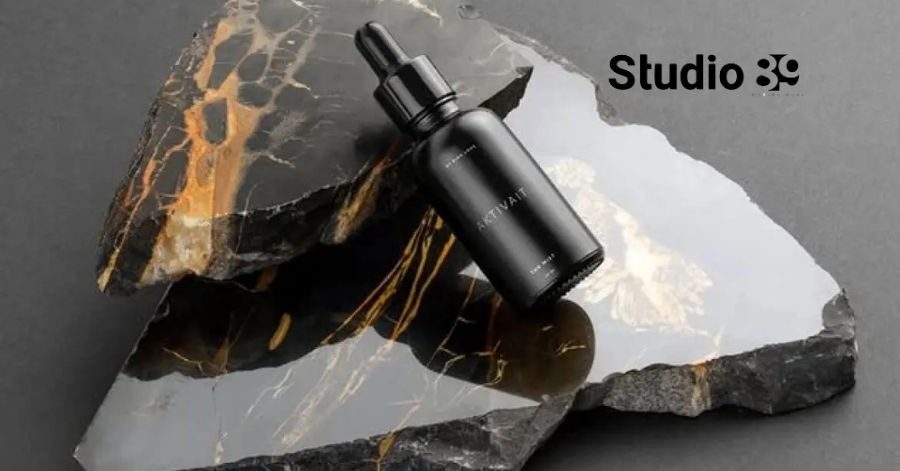 Product photography Dhaka with black skincare bottle on luxury stone surface