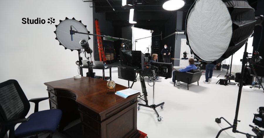 Spacious video production studio Dhaka at Studio 89, featuring a white backdrop and extensive overhead lighting.